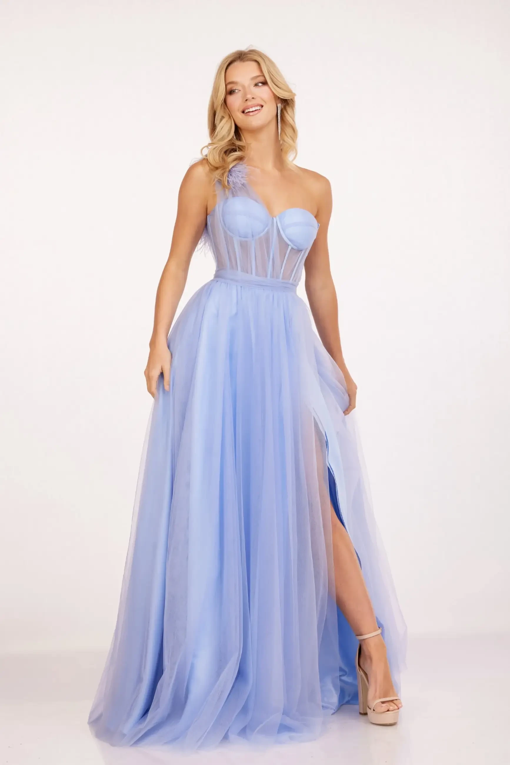 A model wearing a blue evening gown with a sheer overlay and a thigh-high slit.