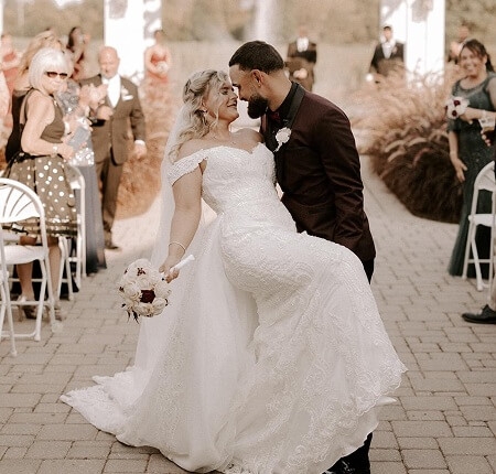 Сouple wearing a white gown and a black suit