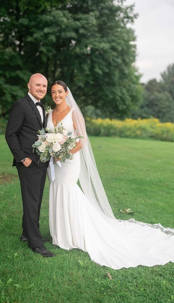 Сouple wearing a white gown and a black suit