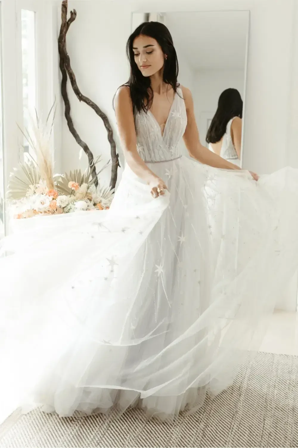 model is wearing a sleeveless bridal gown